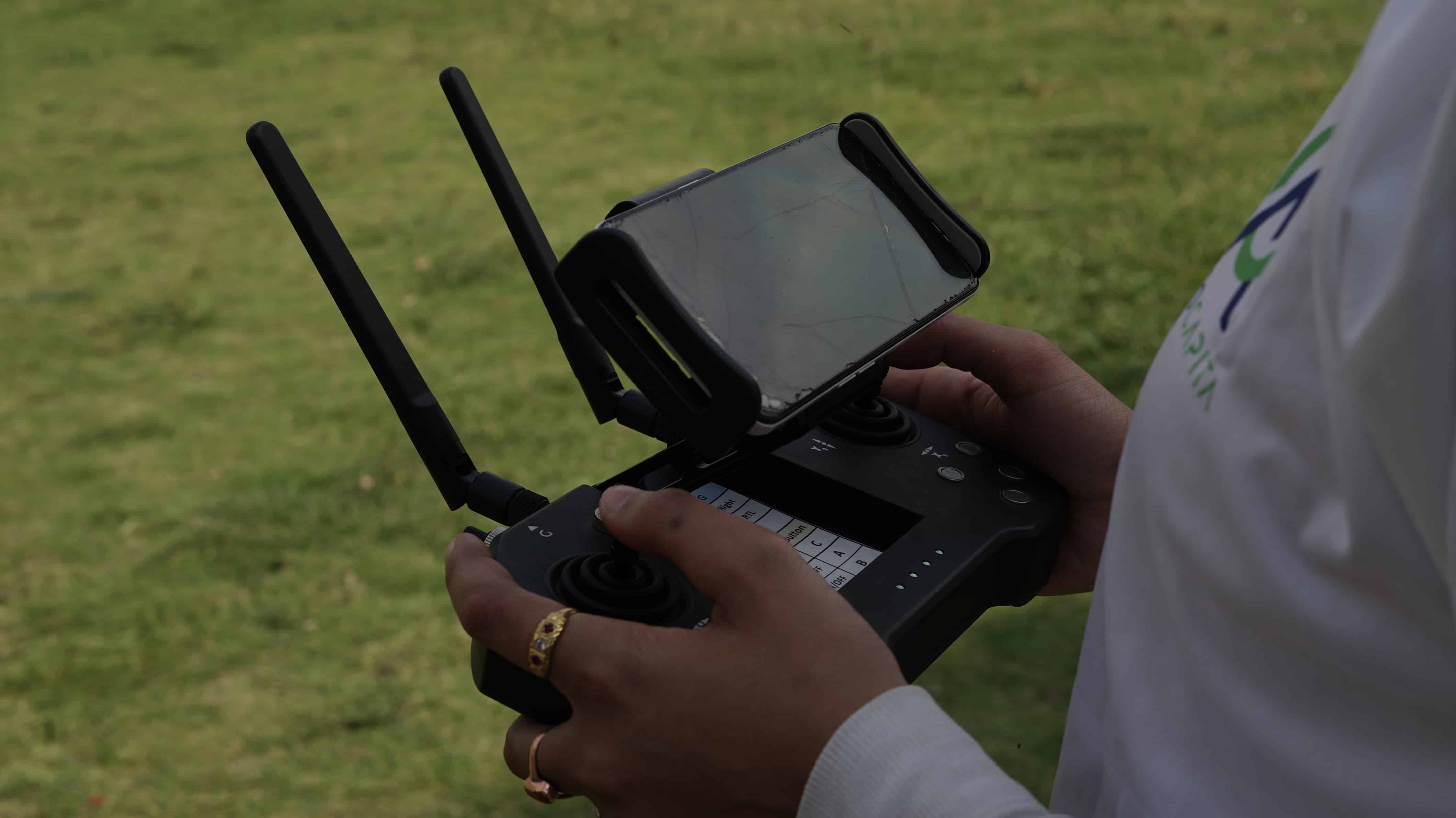 AeroCapita pilot operating the drone controller outdoors